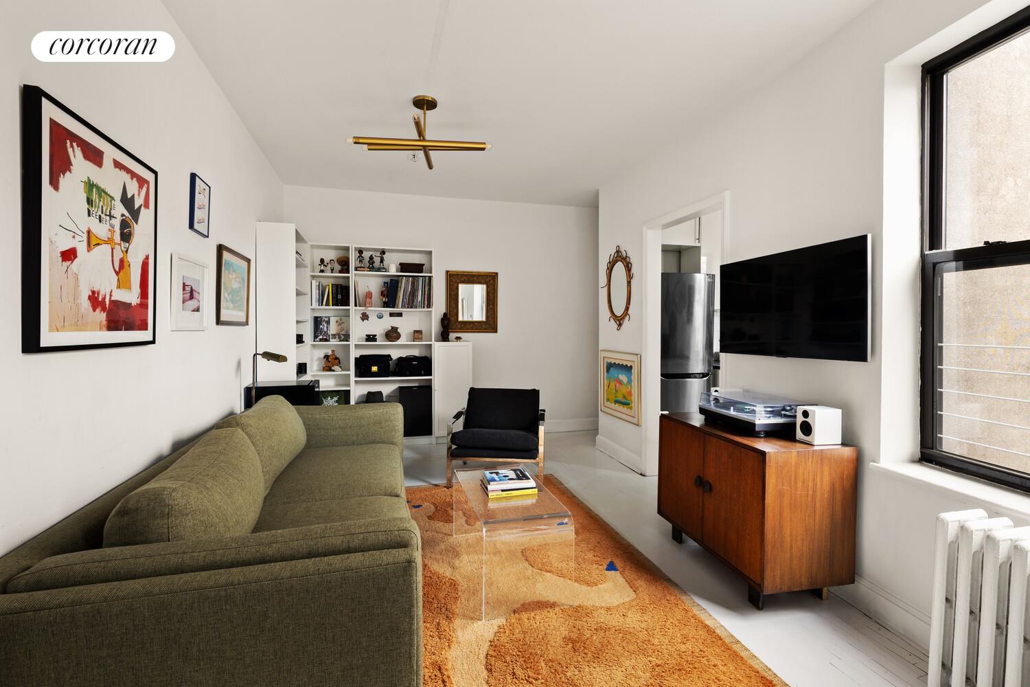 322 6th Street, Unit 20 Brooklyn, NY 11215 - Photo 3 of 7 a living room with furniture and a flat screen tv