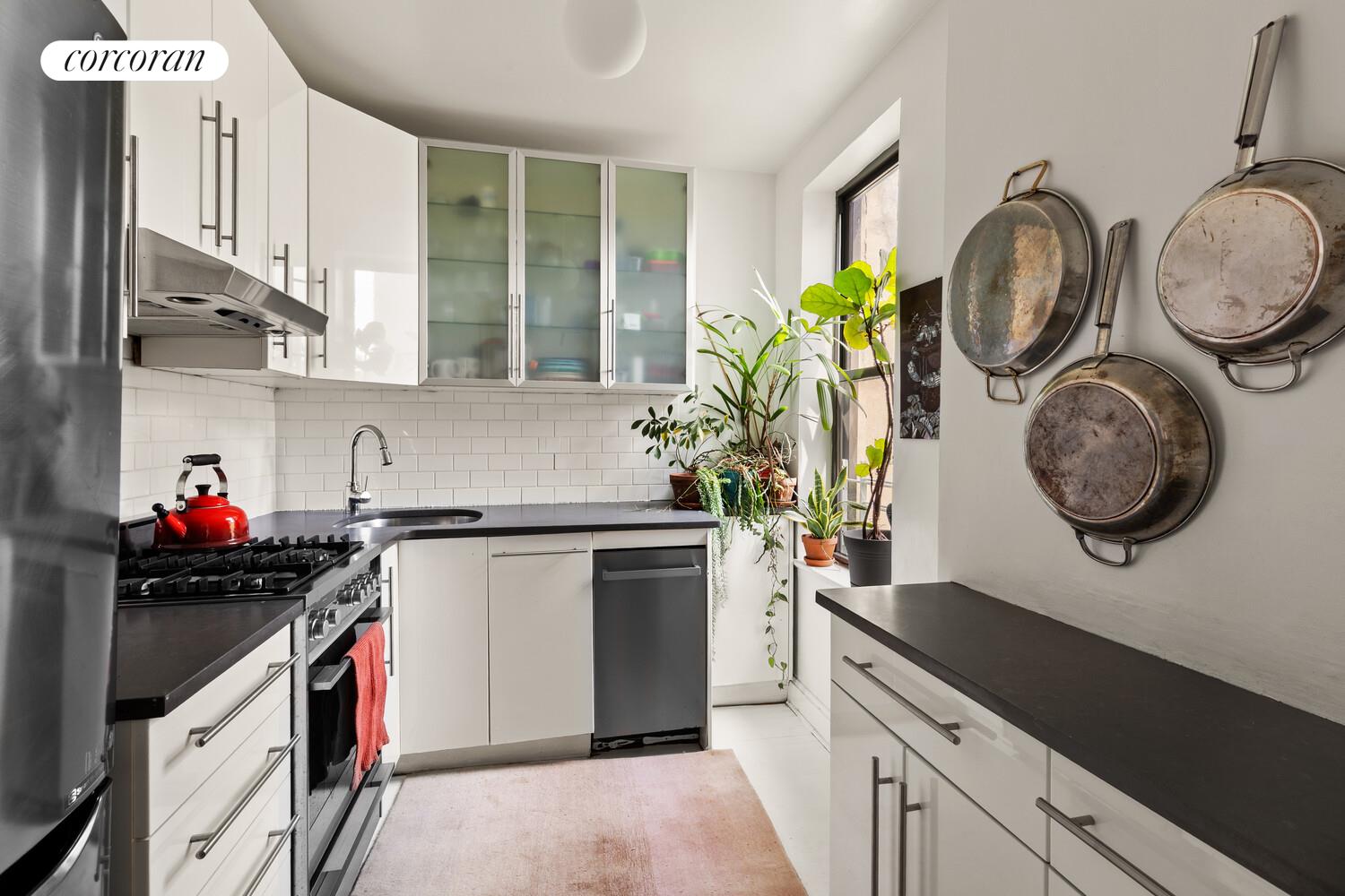 322 6th Street, Unit 20 Brooklyn, NY 11215 - Photo 4 of 7 a kitchen with a stove a sink and a stove