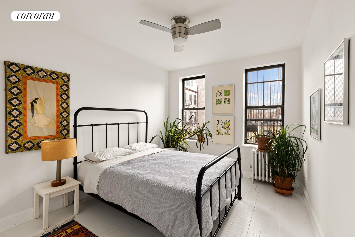 322 6th Street, Unit 20 Brooklyn, NY 11215 - Photo 5 of 7 a bedroom with a bed a potted plant on the dresser and a window