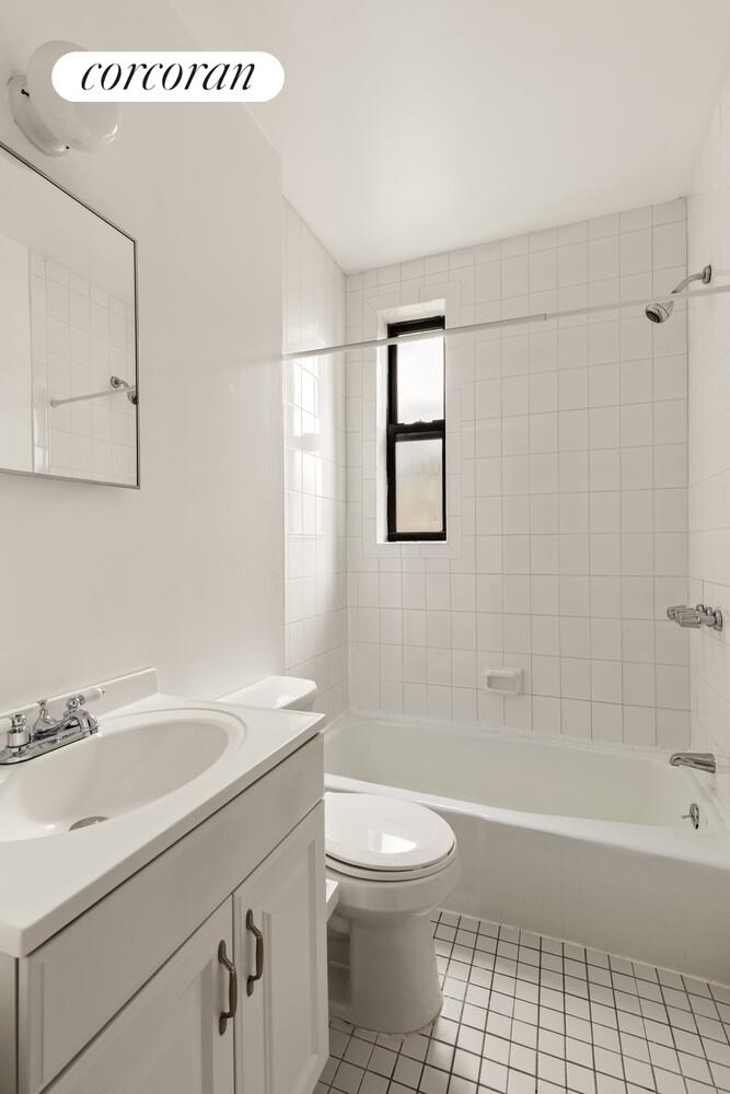 322 6th Street, Unit 20 Brooklyn, NY 11215 - Photo 6 of 7 a bathroom with a sink a toilet and shower
