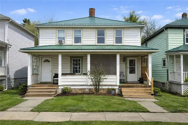 a front view of a house with a garden