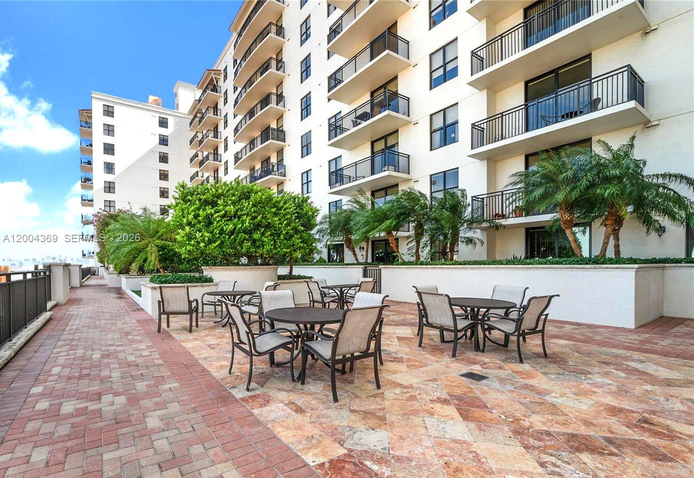 888 Douglas Road, Unit 1512 Coral Gables, FL 33134 - Photo 5 of 12 a view of a building with dining table and chairs