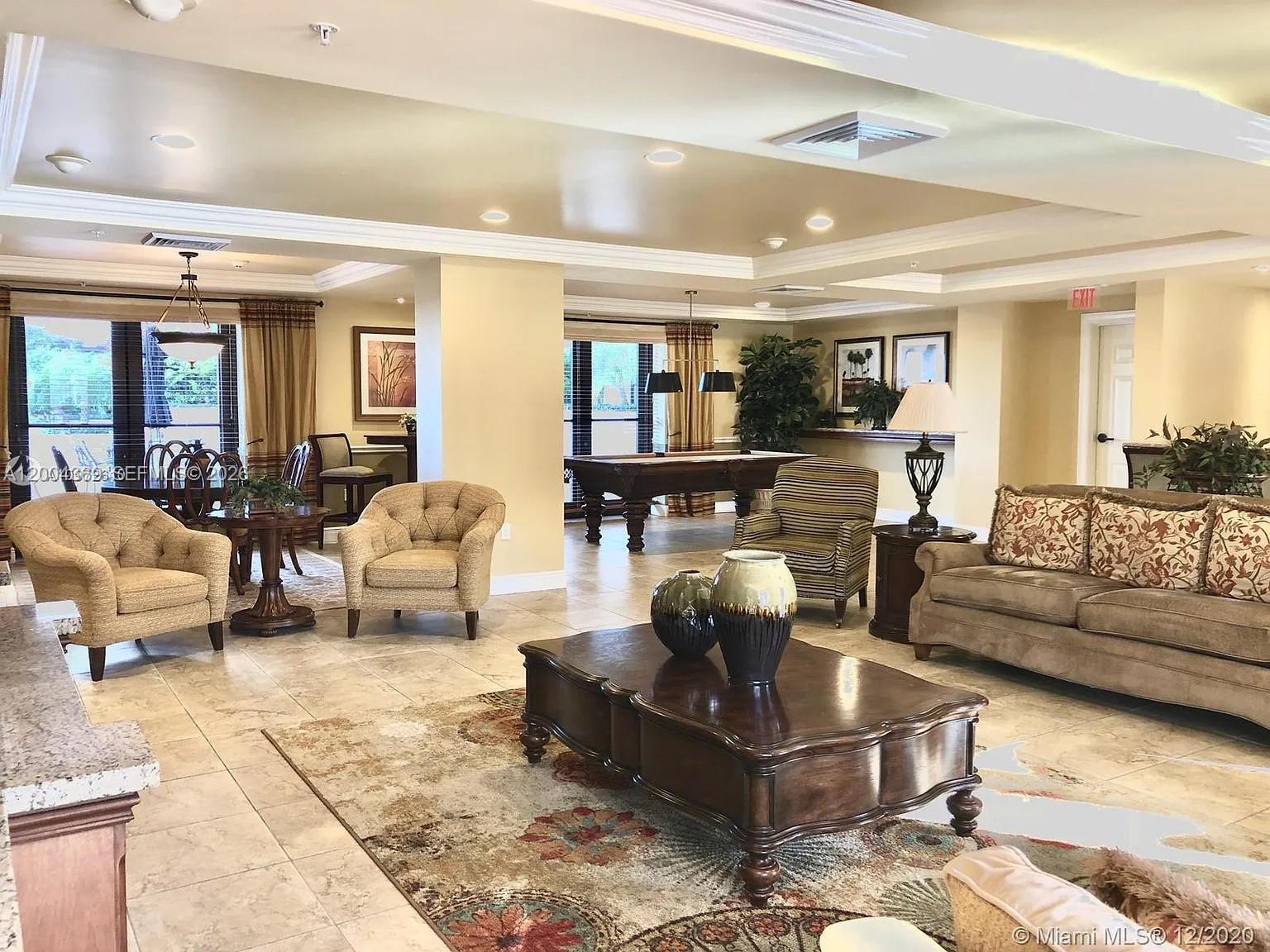 888 Douglas Road, Unit 1512 Coral Gables, FL 33134 - Photo 7 of 12 a living room with fireplace furniture and a rug