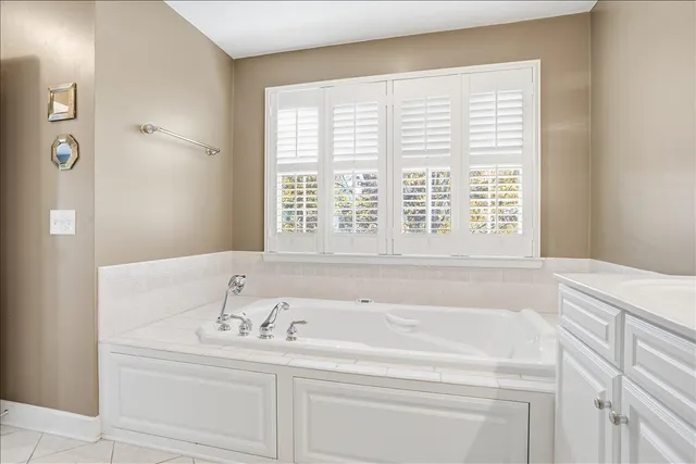 a bathroom with a bathtub and a window