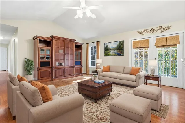 a living room with furniture ceiling fan and a window
