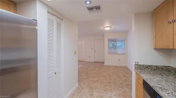 a view of hallway with granite countertop