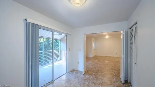 a view of a room with wooden floor and window
