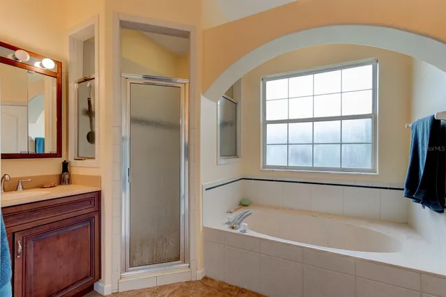 a white bath tub sitting next to a bathroom sink