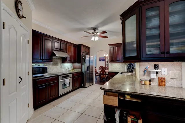 a kitchen with stainless steel appliances granite countertop a sink wooden cabinets and a granite counter tops
