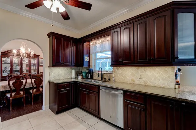 a kitchen with stainless steel appliances granite countertop wooden cabinets a sink and dishwasher
