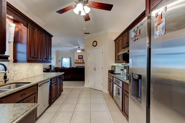a kitchen with stainless steel appliances granite countertop a refrigerator and a sink