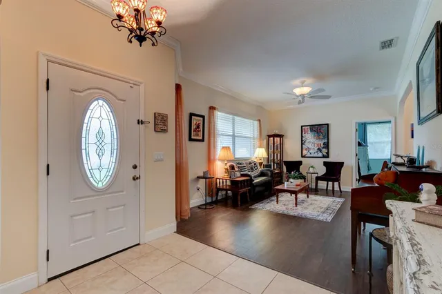 a living room with fireplace furniture and a chandelier