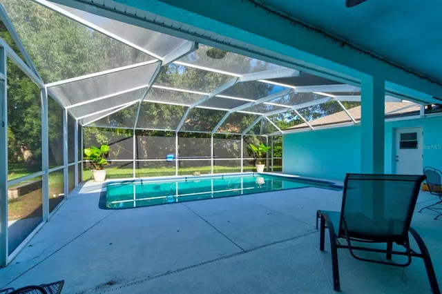 a view of an empty room with table and chairs