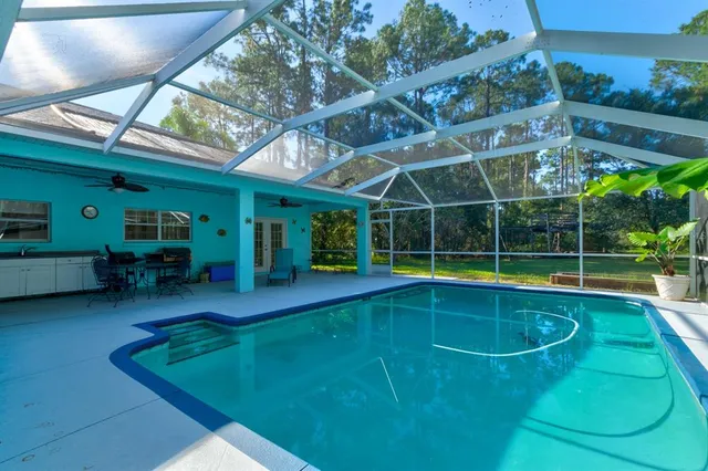 a view of a backyard with swimming pool