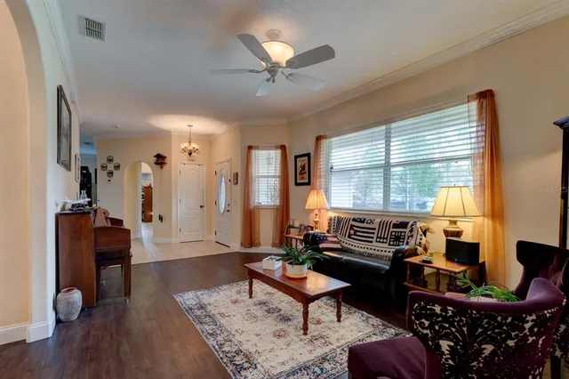 a living room with furniture a window and a chandelier