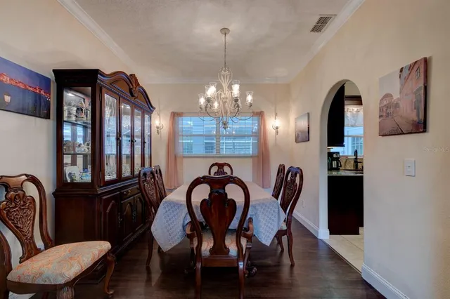 a view of a dining room with furniture and chandelier