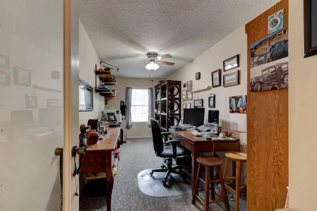 a view of a workspace with furniture and a kitchen