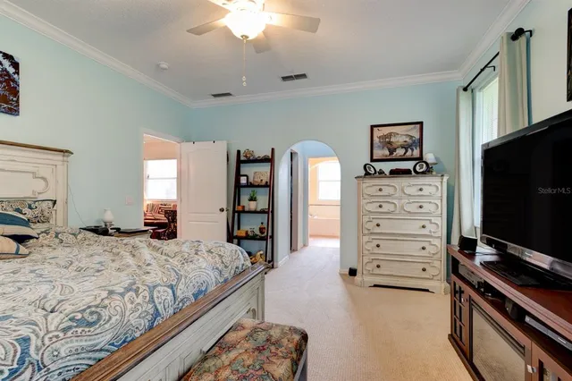 a bedroom with a bed and a television