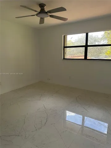 a view of a air conditioner and window in an empty room