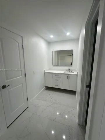 a bathroom with a double vanity sink and mirror