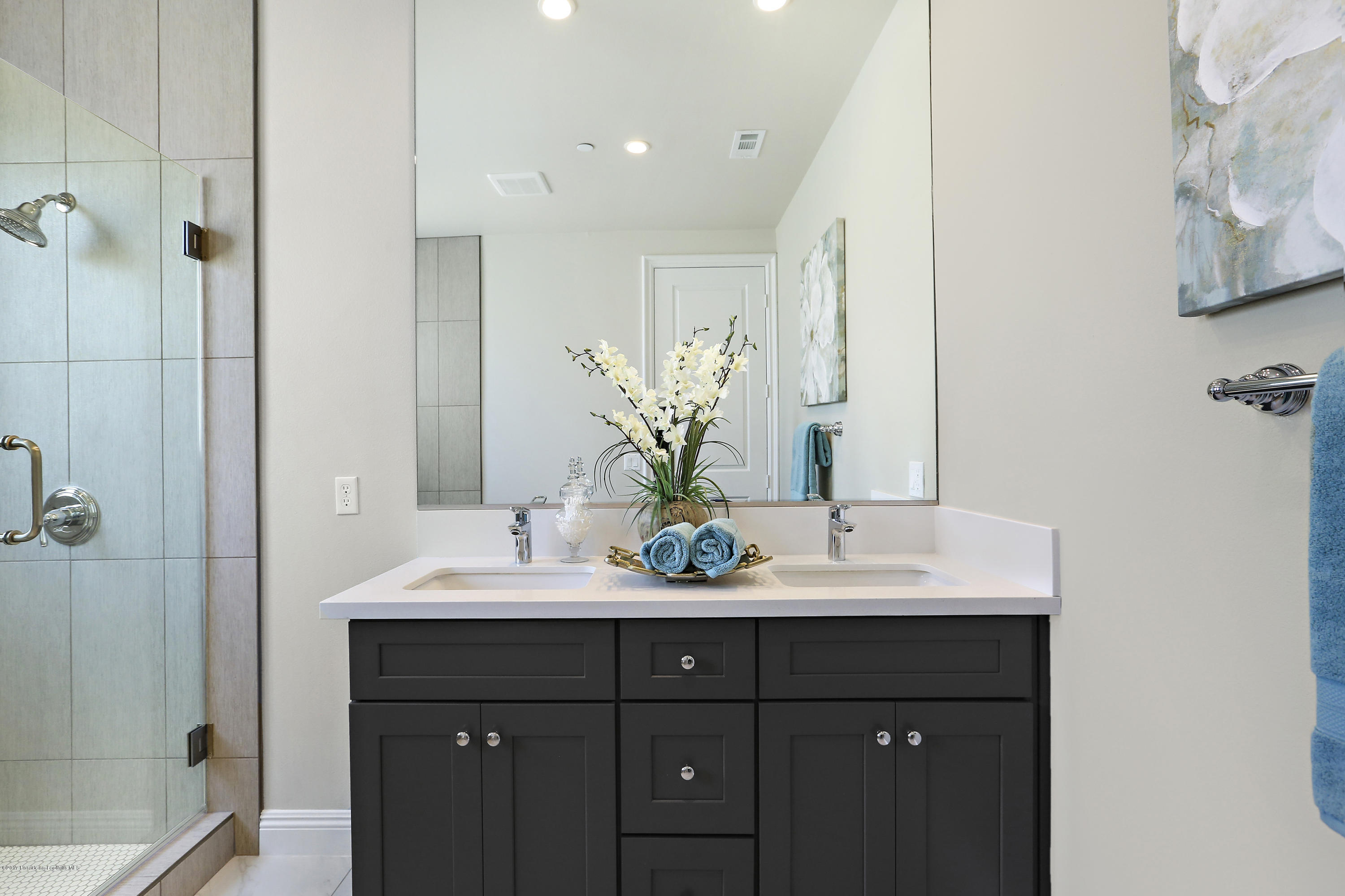 803 Arcadia Avenue, Unit A Arcadia, CA 91007 - Photo 39 of 42 a bathroom with a double vanity sink and a mirror