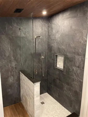 a bathroom with a sink a mirror and a potted plant