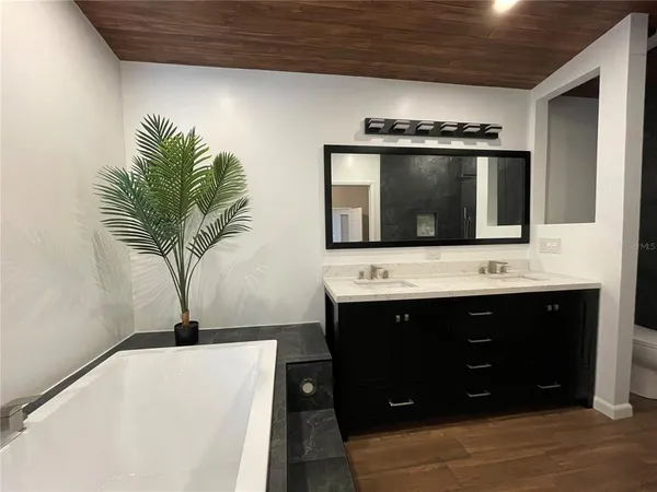a view of hallway with wooden floor