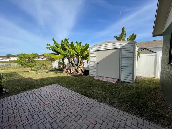 a view of empty room with window and ceiling fan