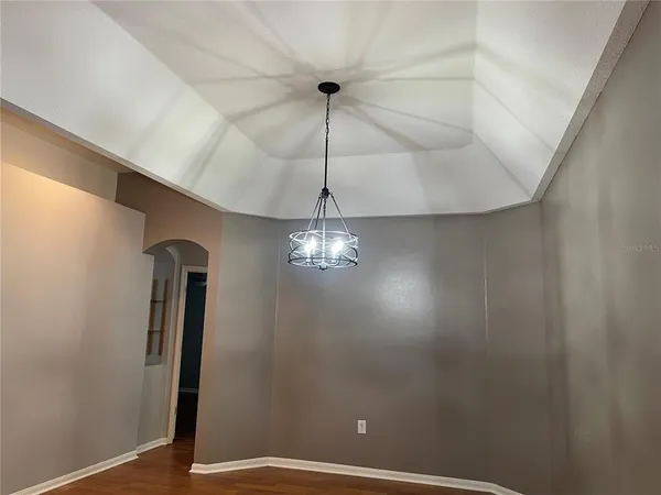 an empty room with a window and wooden floor