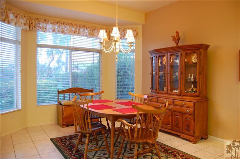 39495 Manorgate Road Palm Desert, CA 92211 - Photo 12 of 22 a view of a dining room with furniture and chandelier