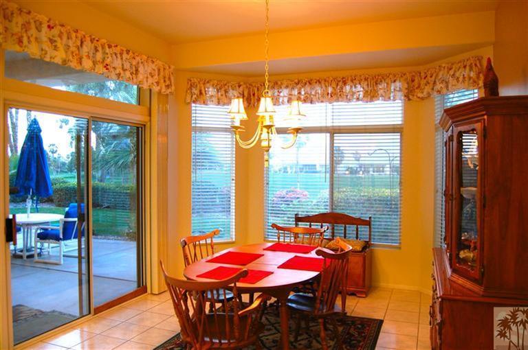 39495 Manorgate Road Palm Desert, CA 92211 - Photo 13 of 22 a dining room with furniture and wooden floor