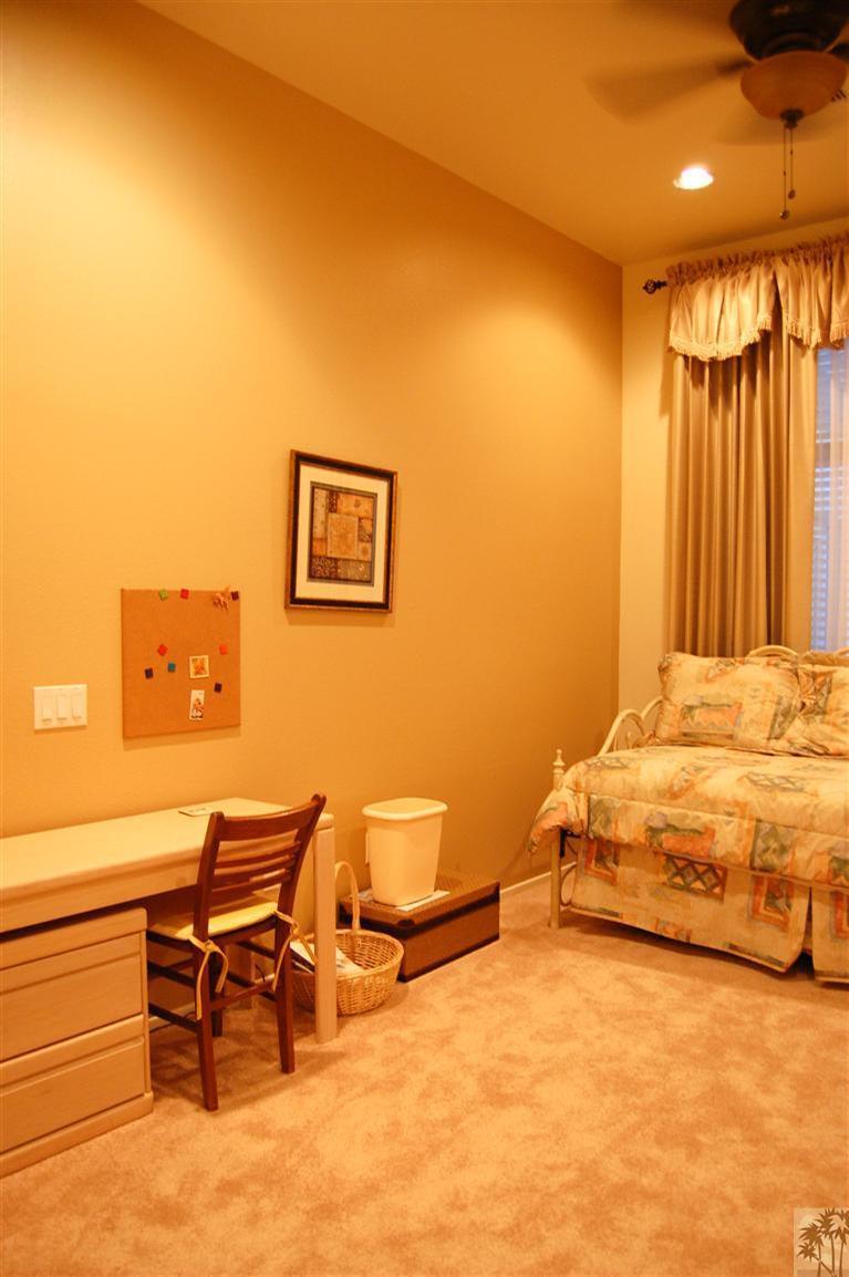 39495 Manorgate Road Palm Desert, CA 92211 - Photo 15 of 22 a spacious bedroom with a bed and chair