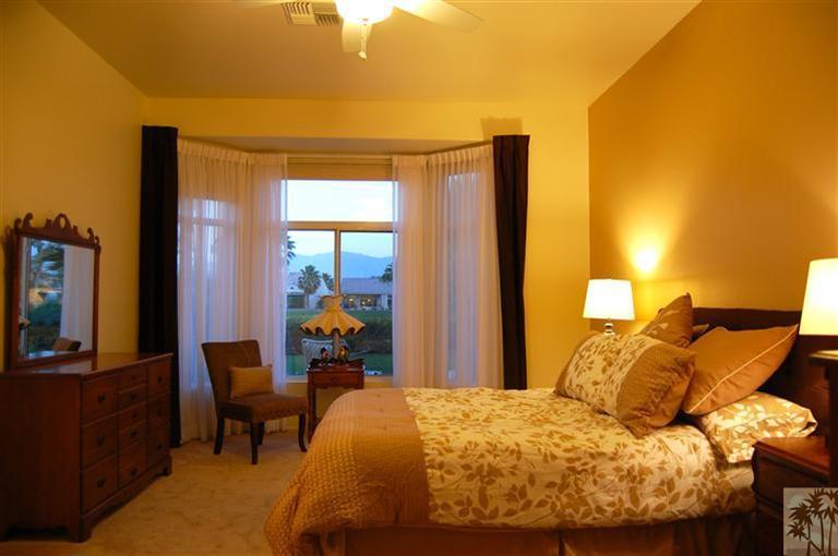 39495 Manorgate Road Palm Desert, CA 92211 - Photo 17 of 22 a bedroom with a bed and wooden floor