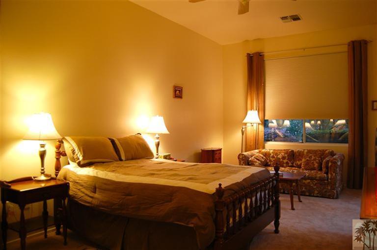 39495 Manorgate Road Palm Desert, CA 92211 - Photo 19 of 22 a bedroom with a bed a lamp and a table