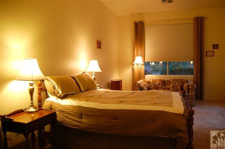 39495 Manorgate Road Palm Desert, CA 92211 - Photo 20 of 22 a bedroom with a bed and lamp