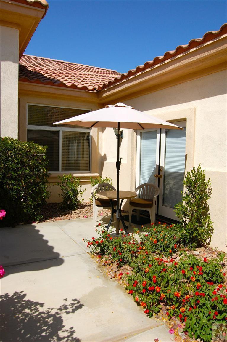 39495 Manorgate Road Palm Desert, CA 92211 - Photo 2 of 22 front view of a house with a bench