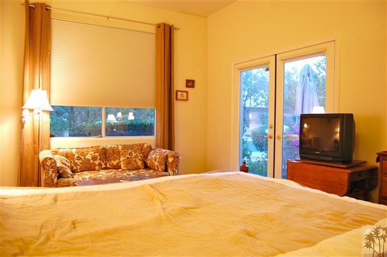39495 Manorgate Road Palm Desert, CA 92211 - Photo 21 of 22 a bedroom with a large window and a flat screen tv