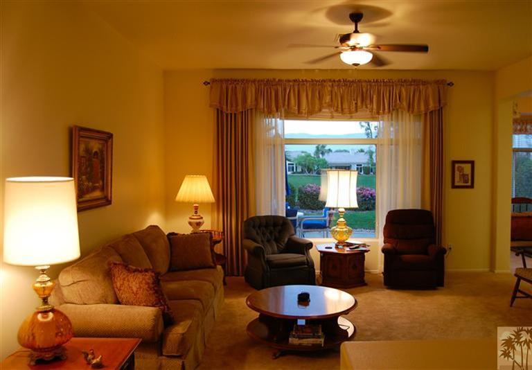 39495 Manorgate Road Palm Desert, CA 92211 - Photo 8 of 22 a living room with furniture and a lamp