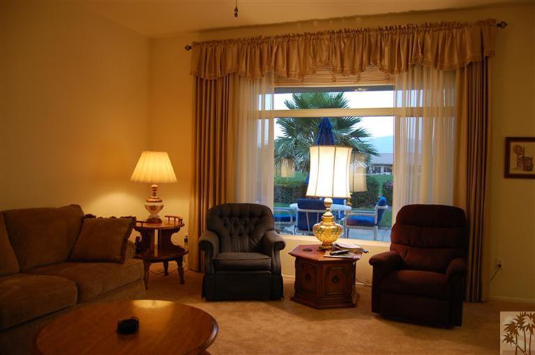 39495 Manorgate Road Palm Desert, CA 92211 - Photo 9 of 22 a living room with furniture and a large window
