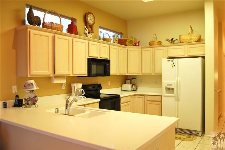 39495 Manorgate Road Palm Desert, CA 92211 - Photo 10 of 22 a kitchen with stainless steel appliances granite countertop a sink and a refrigerator