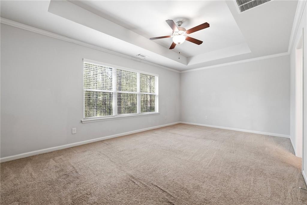 331 Turtle Creek Drive Winder, GA 30680 - Photo 14 of 25 an empty room with ceiling fan and windows