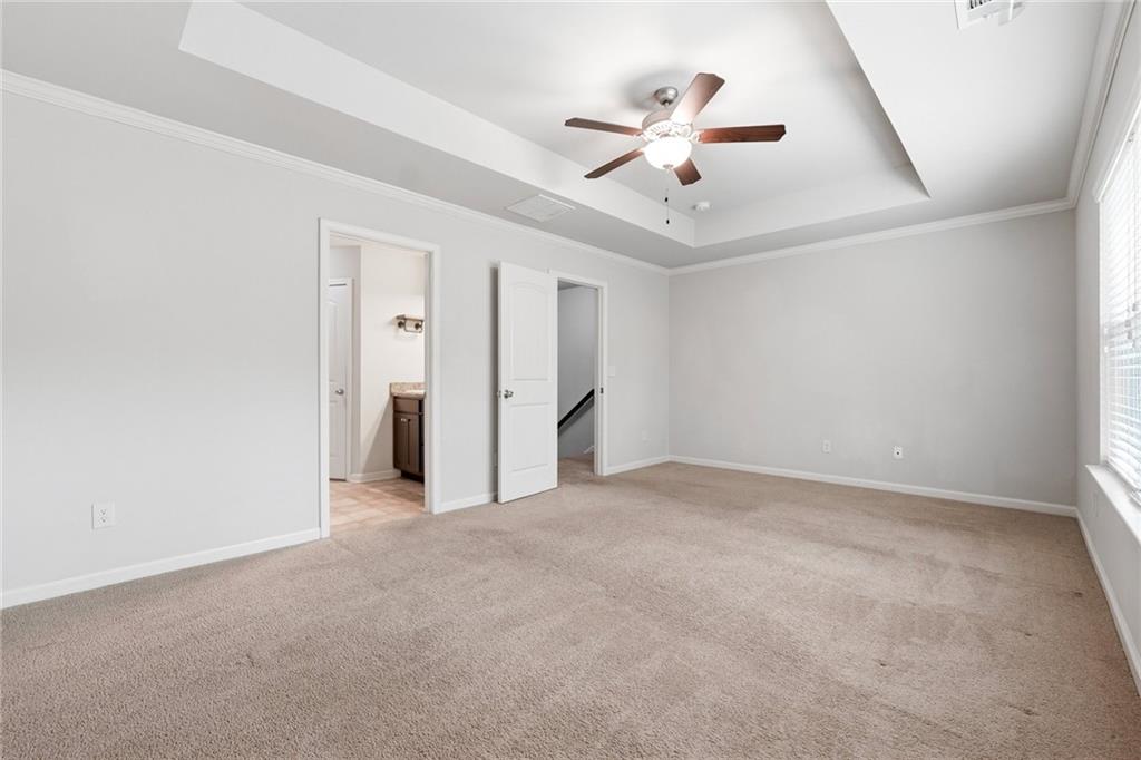 331 Turtle Creek Drive Winder, GA 30680 - Photo 15 of 25 an empty room with chandelier fan and windows
