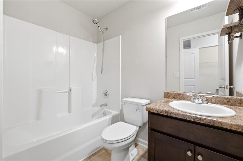 331 Turtle Creek Drive Winder, GA 30680 - Photo 21 of 25 a bathroom with a sink toilet vanity and shower