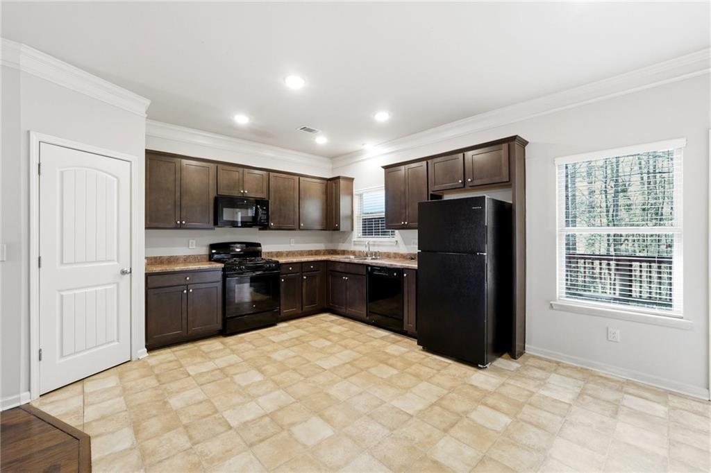 331 Turtle Creek Drive Winder, GA 30680 - Photo 10 of 25 a kitchen with a refrigerator and a stove top oven