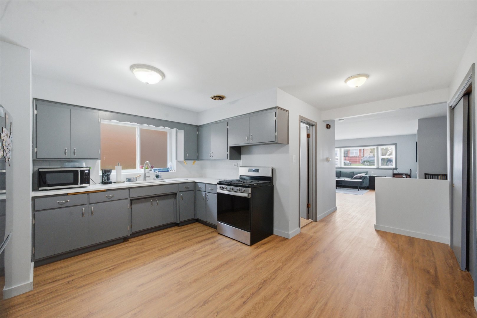 7412 West 63rd Place Summit, IL 60501 - Photo 16 of 49 a kitchen with granite countertop a refrigerator stove top oven and sink
