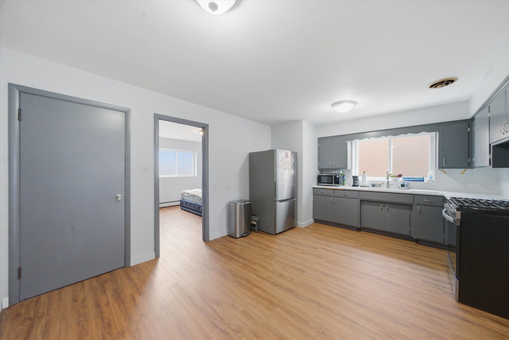 7412 West 63rd Place Summit, IL 60501 - Photo 17 of 49 a kitchen with stainless steel appliances kitchen island granite countertop a refrigerator and a sink