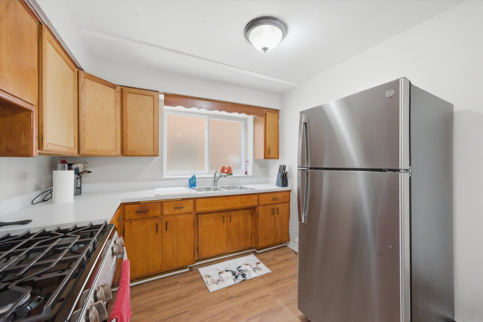 7412 West 63rd Place Summit, IL 60501 - Photo 19 of 49 a kitchen with stainless steel appliances granite countertop a refrigerator and a sink