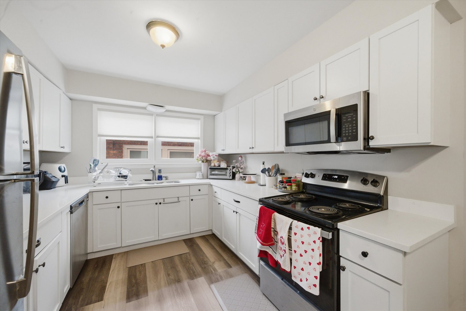 7412 West 63rd Place Summit, IL 60501 - Photo 21 of 49 a kitchen with a sink stove and microwave