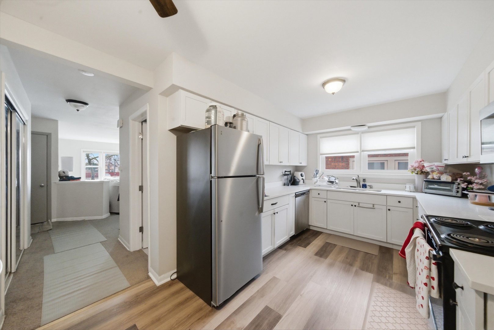 7412 West 63rd Place Summit, IL 60501 - Photo 22 of 49 a kitchen with a refrigerator a sink and cabinets
