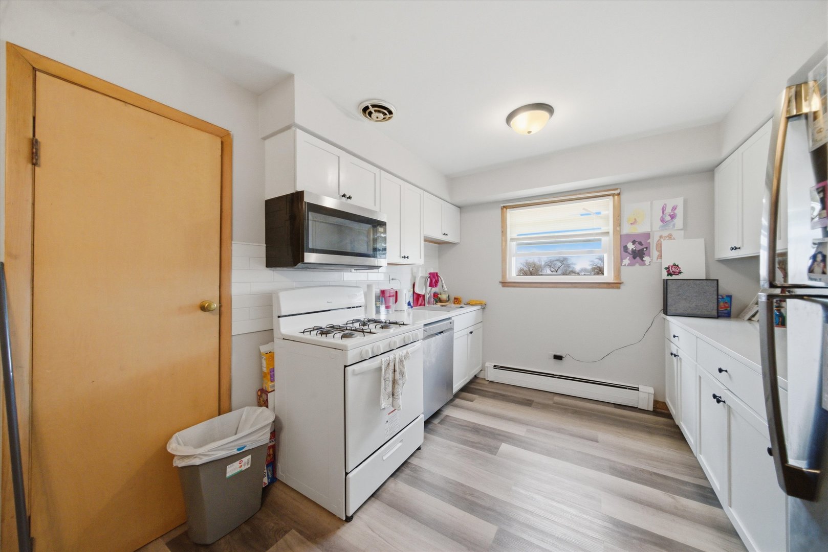7412 West 63rd Place Summit, IL 60501 - Photo 24 of 49 a kitchen with a sink stove and refrigerator